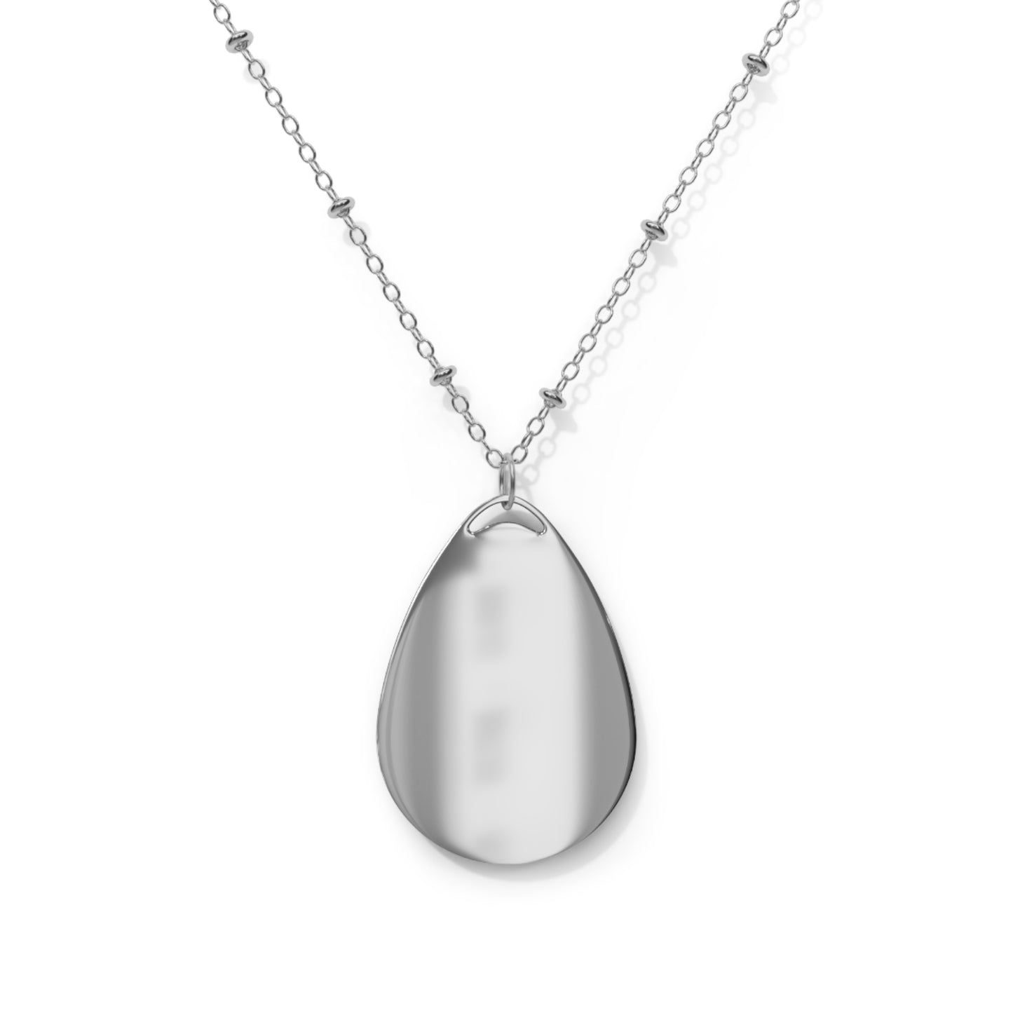 Close-up of Sexy Mess oval pendant necklace styled with minimalist outfit