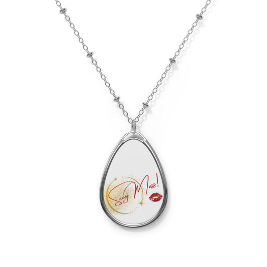 Close-up of Sexy Mess oval pendant necklace styled with minimalist outfit